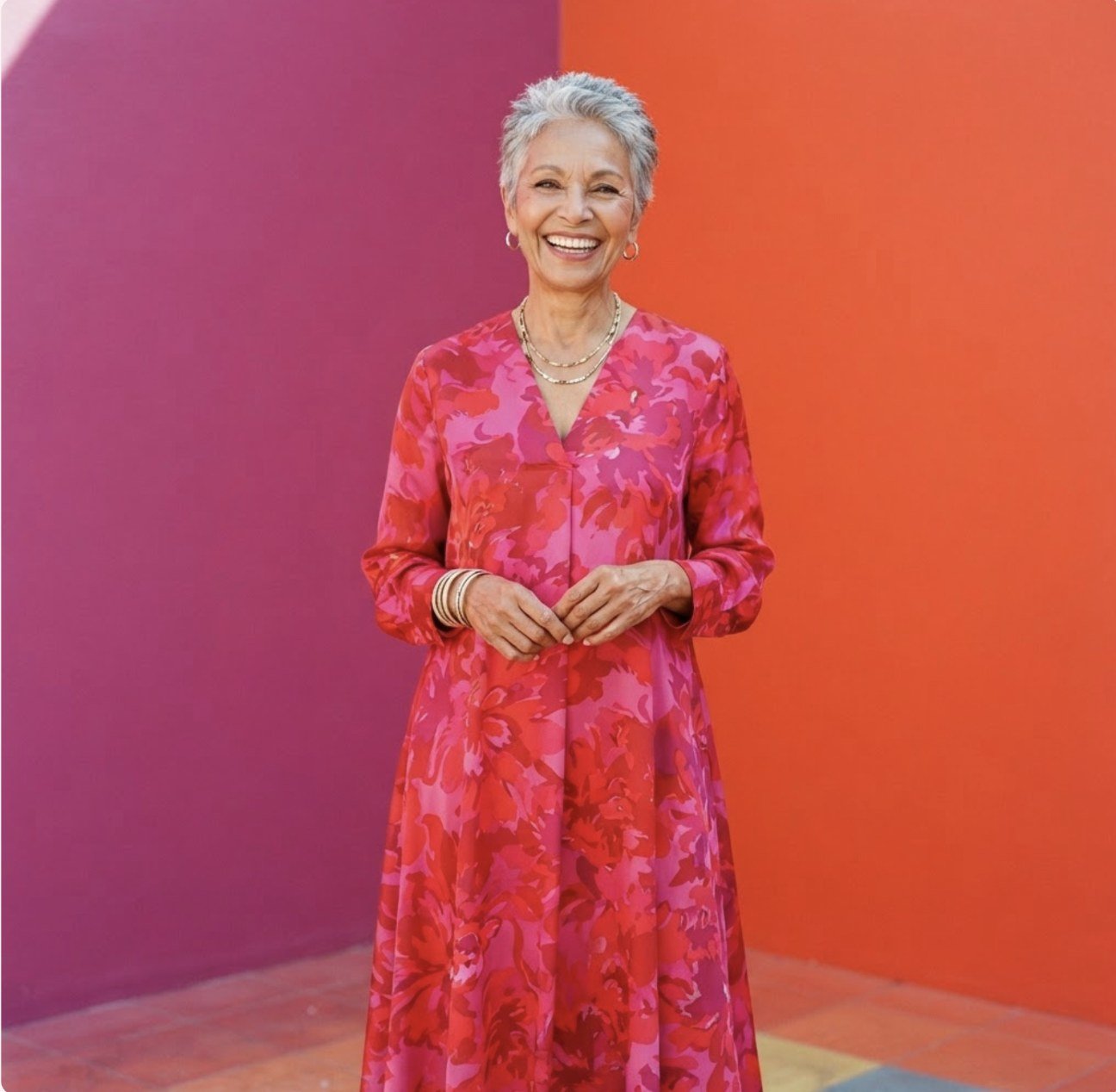 A woman in pink and red against a field of colour